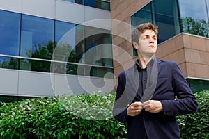 Business man standing in front of office building