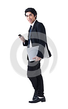 Business man standing with laptop and phone