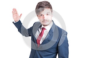 Business man standing looking violent with hand up