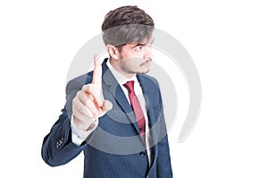 Business man standing showing wait gesture