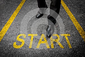 Business man standing on tarmac road background with yellow start text concept. Top view. Businessman with starting challenge of