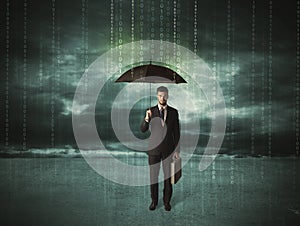 Business man standing with umbrella data protection concept