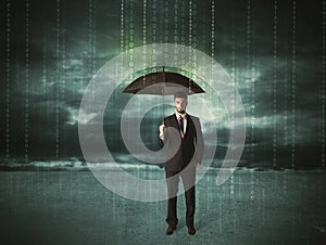 Business man standing with umbrella data protection concept