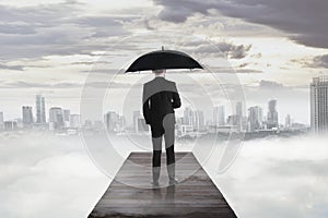 Business man standing on the wooden pier