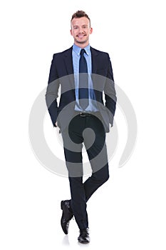 Business man stands with both hands in pockets