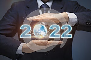 Business man start up business in 2022. Businessman hold world map and 2022 show happy new year 2022, Business Goal, Future plan,