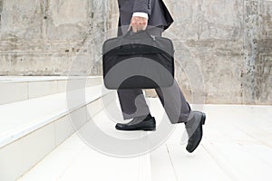 Business man step up stair.Lower part of Man in business shoes walking up stair,People lifestyle successful and competition