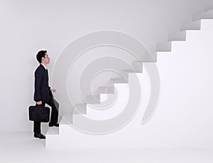 Business man stepping up on stairs