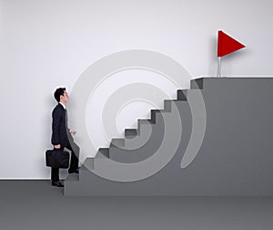 Business man stepping up on stairs to red flag (business success