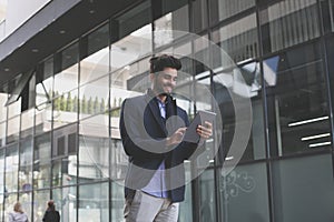 Business man on street using iPod.