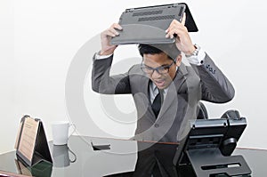 Business man stress and brake a laptop