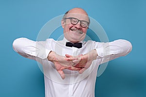 Business man stretching his muscles finishing hard working day.