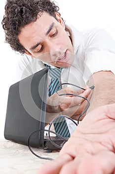 Business man in suit addicted to internet put USB cable from lap