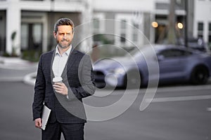 Business man in suit. Businessman walking in city. Hispanic man walk on street. Business man with laptop and coffee