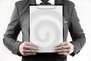 Business man in suit holding a blank clipboard