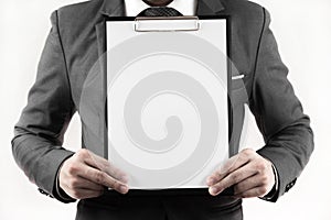 Business man in suit holding a blank clipboard