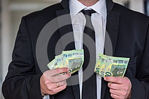 Business man in suit holding euro and dollar banknote for exchange rate.