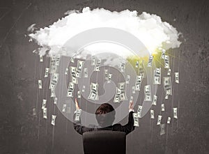 Business man in suit looking at cloud with falling money