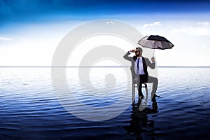 A business man in a suit with an umbrella