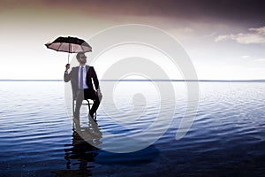 A business man in a suit with an umbrella