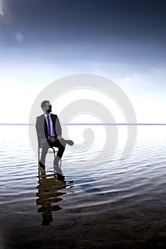 A business man in a suit on water