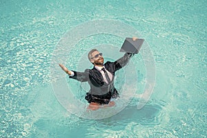 business man on summer vacation. businessman in wet suit in pool. Remote working. Summer business dreams. successful man