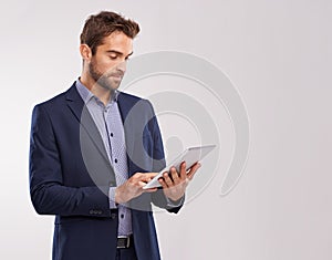 Business man with tablet, technology or corporate communication isolated on studio background. Internet, connectivity or