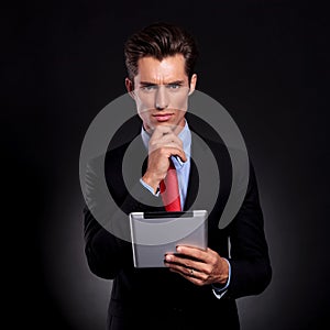 Business man with tablet thinking