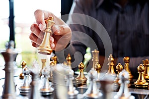 Business man take a king figure checkmate on the chess board game - strategy, management or leadership success concept