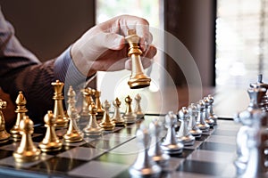 Business man take a king figure checkmate on the chess board game - strategy, management or leadership success concept