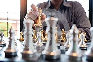 Business man take a king figure checkmate on the chess board game - strategy, management or leadership success concept