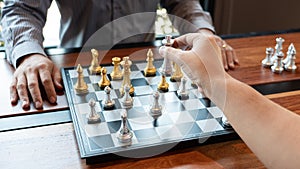 Business man take a king figure checkmate on the chess board game - strategy, management or leadership success concept