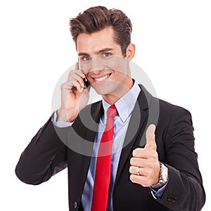 Business man talking on the phone and making ok