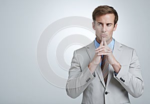 Business man, thinking and planning in studio, brainstorming and problem solving by white background. Male person