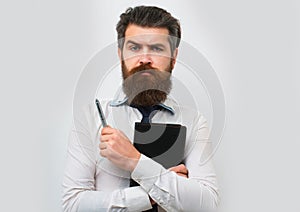 Business man is thinking about something with pencil. Business dreams. Thoughtful young man in shirt and tie holding