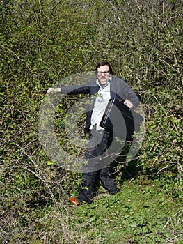 Business man in thorn bushes