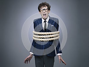 Business man tied up with rope