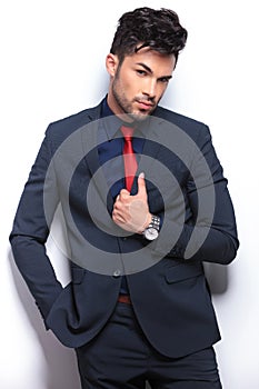 Business man with tilted head and hand on lapel