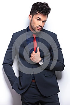 Business man with tilted head and hand on lapel photo