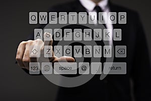 Business man touching imaginery screen with keypad