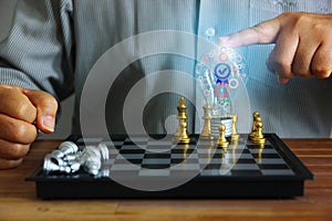 Business man touching light bulb among golden chess pieces on board .  illustration gears and guarantee icon in light bulb idea