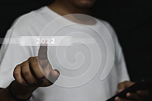 Business man touching screen with 2022 writing on virtual screen