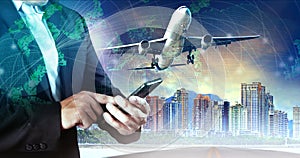 Business man touching on smart phone and air plane flying mid ai photo