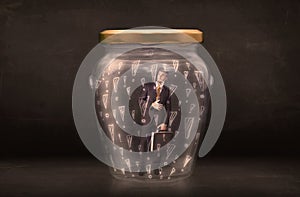 Business man trapped in jar with exclamation marks concept