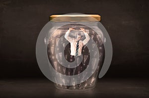 Business man trapped in jar with exclamation marks concept