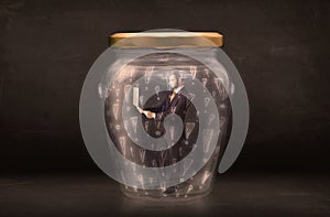 Business man trapped in jar with exclamation marks concept