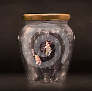 Business man trapped in jar with exclamation marks concept