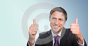 Business man two thumbs up against blue background