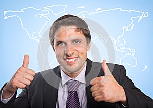 Business man with two thumbs up against white map and blue background