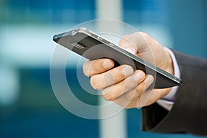 Business Man Typing With Finger On Phablet Smartphone